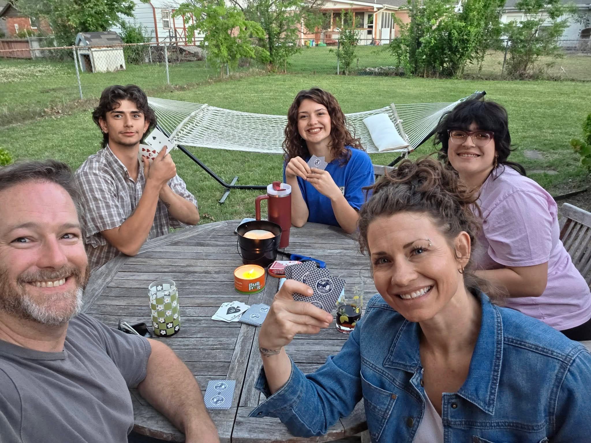 Kyle Hearn enjoying an evening of cards outdoors with his family